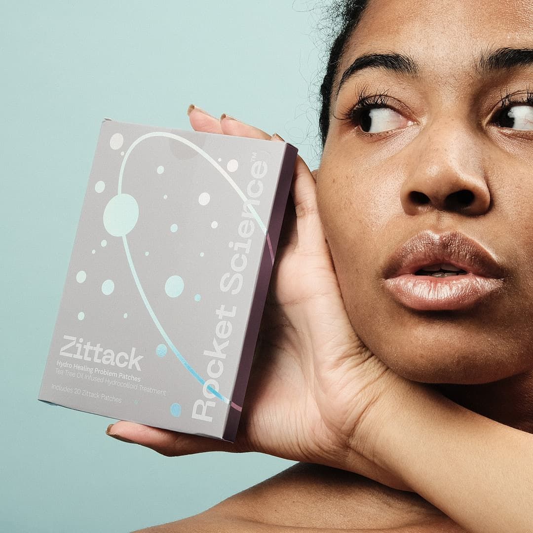 Photo of a woman holding a Rocket Science product packaging